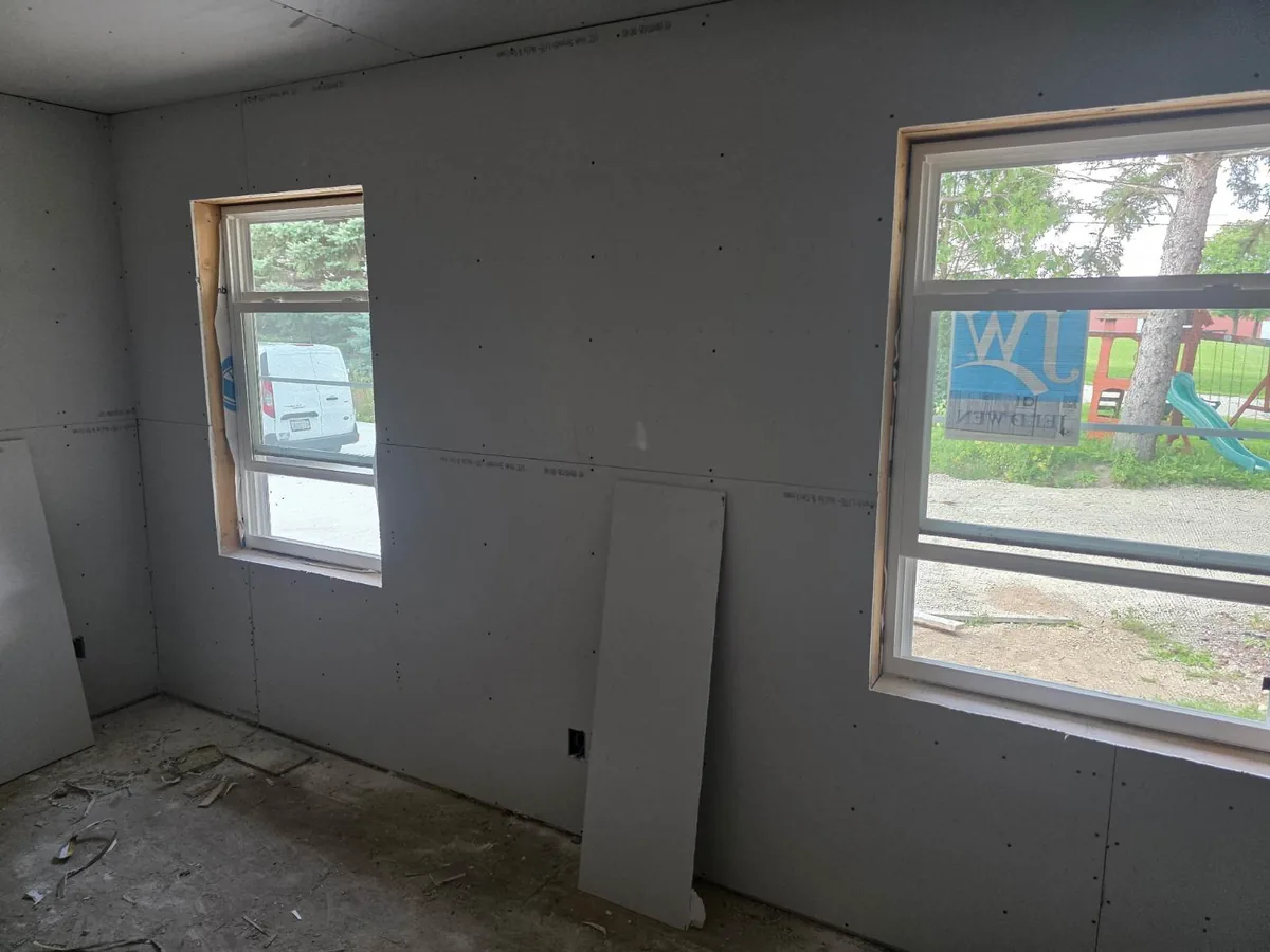 Drywall hung around two bedroom windows