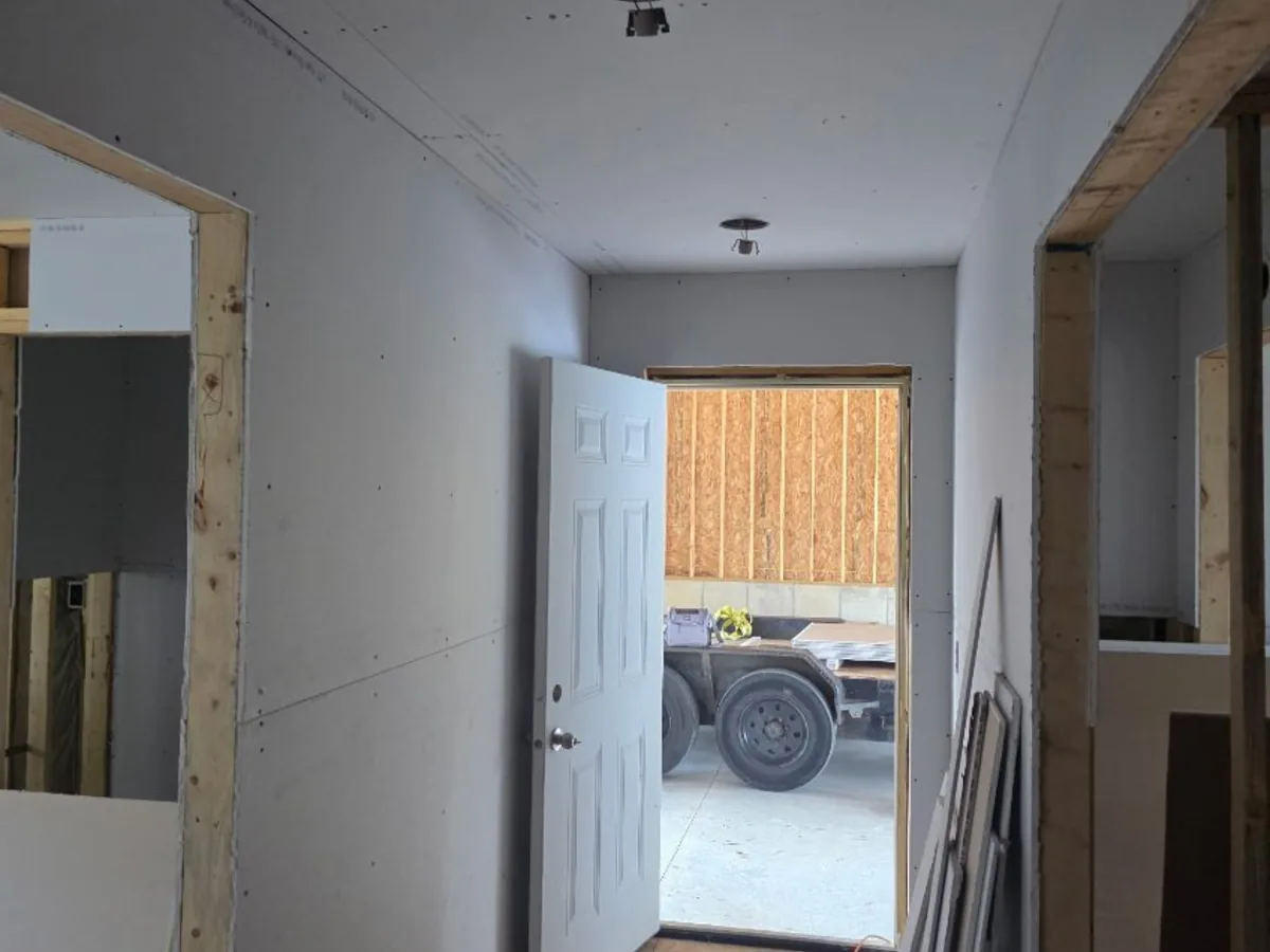 Drywall hung along a hallway and doorway