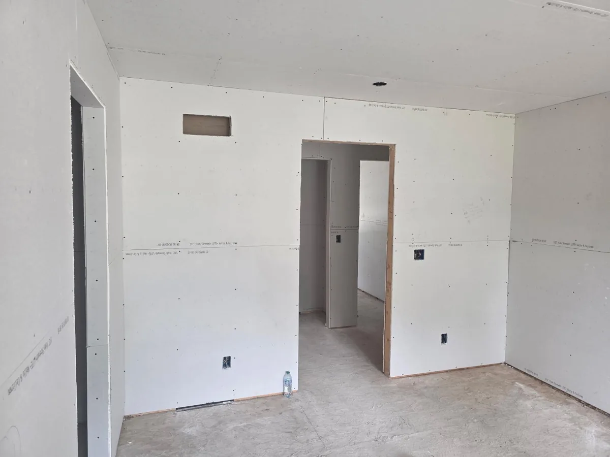 Drywall hung and taped around two doorways