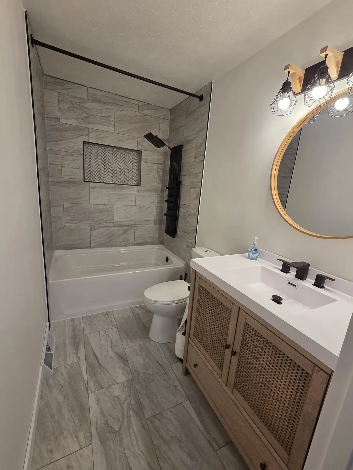 Gray flooring and walls bathroom remodel