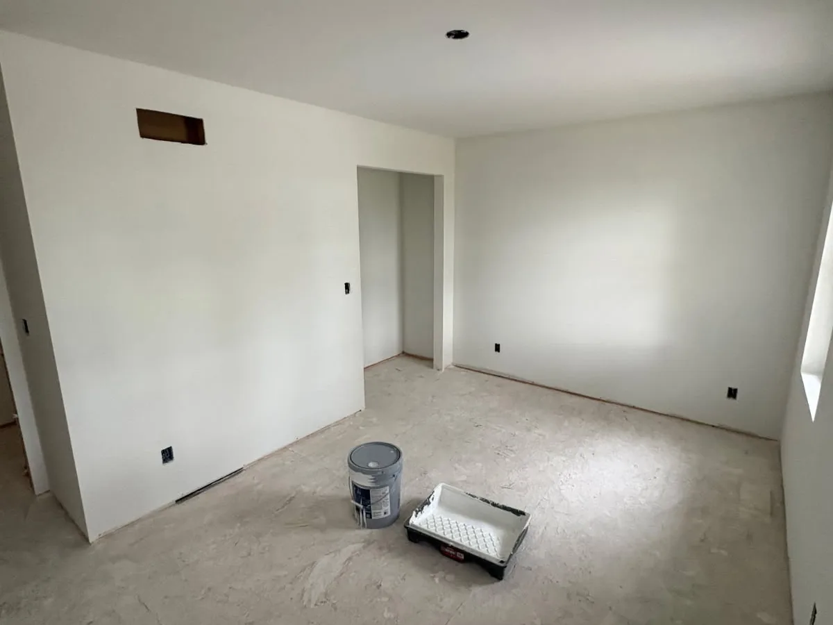 Primed drywall walls in a finished room
