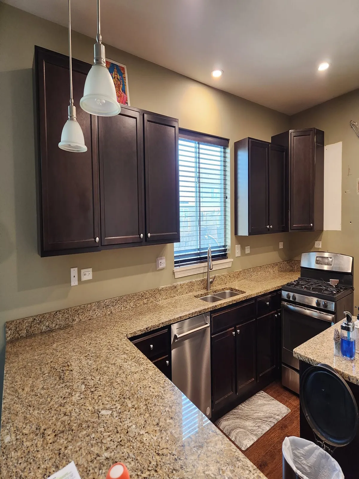 Marble kitchen remodel with brown cabinets