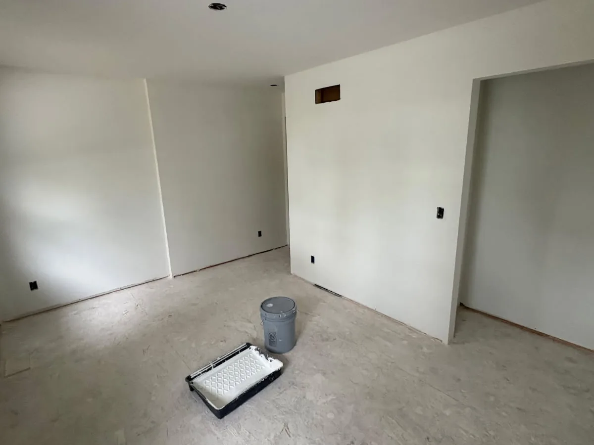 Primed white drywall walls in a finished bedroom